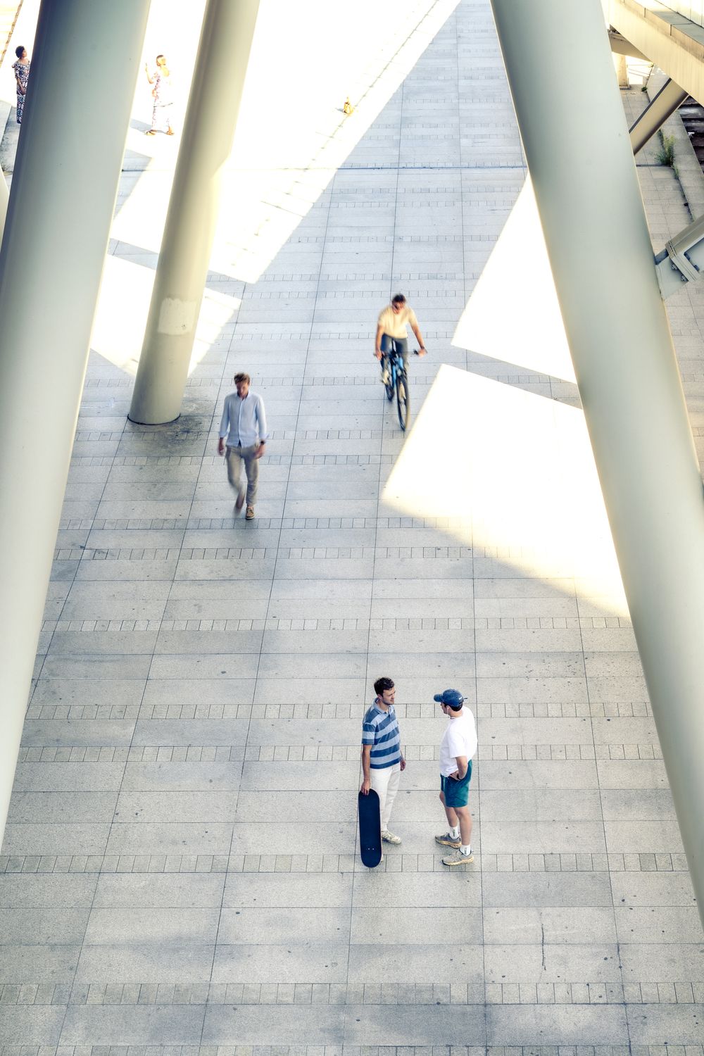 Runners of Mace crossing a station square between tall columns