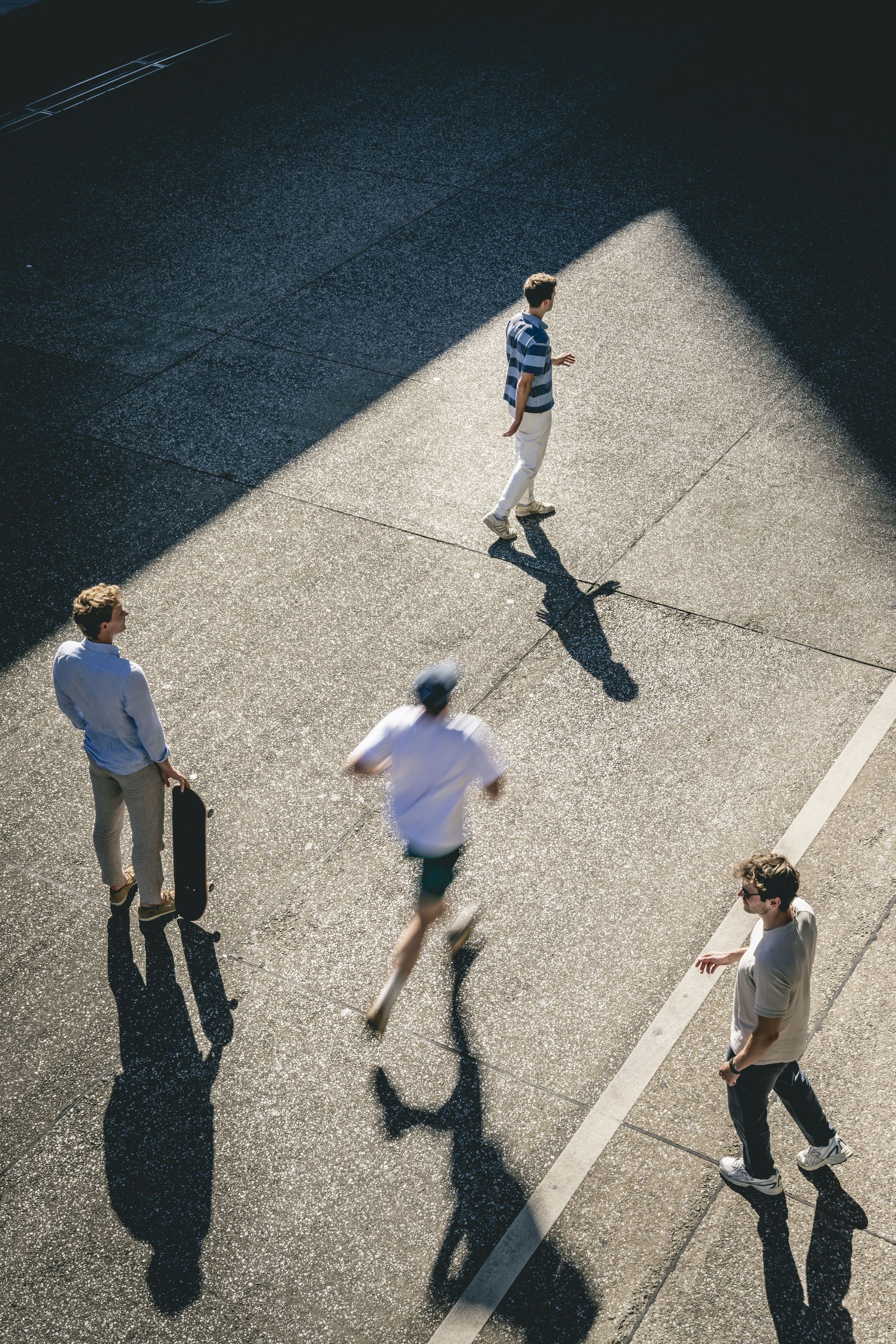 Four Mace Runners crossing a sunlit station square, seen from above